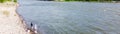 Panorama aerial view couple of Asian fisherman fishing along spillway of Denison Dam when water is generating releasing