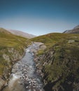 Panorama aerial view of a hiking area in a rocky environment with arctic meadows in summer. River on Island of kuannit