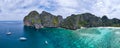 Panorama and aerial view of Maya beach with some boat sail in left side and sunny blue sky and beautiful green color water