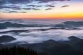 Panorama with amazing sunrise. Landscape with high mountains. Fields and meadow are covered with morning fog and dew. Touristic Royalty Free Stock Photo