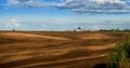 Panorama of brown arable land over amazing clouds Royalty Free Stock Photo