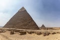 Panorama of the area with the great pyramids of Giza with Pyramid of Khafre or Chephren and the Pyramid of Menkaure in the far Royalty Free Stock Photo