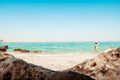 Panorama attractive caucasian tourist woman in white bikini walk on white sand beach alone explore middle east.Persian gulf