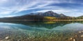 Panorama of autumn aspens reflected in the Rocky Mountains Royalty Free Stock Photo
