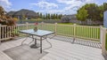 Panorama Balcony with view of the spacious yard under cloudy blue sky on a sunny day