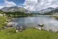 Panorama of Banderishki Chukar and Todorka Peaks and reflection in Muratovo lake, Pirin Mountain Royalty Free Stock Photo