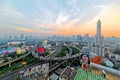 Panorama of Bangkok at dusk with skyscrapers in background and busy traffic on elevated expressways & circular interchanges Royalty Free Stock Photo