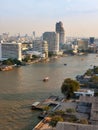 Panorama of Bangkok with the river and boats at sunset.