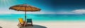 Panorama banner of two chairs and a sun umbrella on an exotic beach on a sunny day with clear blue water and sunny sky Royalty Free Stock Photo