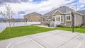 Panorama Basketball court and swings on the spacious yard of a single storey family home