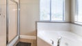 Panorama Bathroom interior with corner bathtub and shower stall with glass and aluminum frame