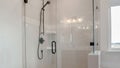 Panorama Bathroom shower stall with half glass enclosure adjacent to built in bathtub Royalty Free Stock Photo