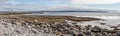 Panorama with beach, Lighthouse  and cliffs of Moher in background in Inisheer island Royalty Free Stock Photo