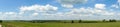 Panorama. Beautiful landscape. Green field with clouds. Russia