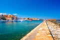 Panorama of the beautiful old harbor of Chania with the amazing lighthouse, mosque, venetian shipyards, at sunset, Crete. Royalty Free Stock Photo