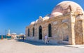 Panorama of the beautiful old harbor of Chania with the amazing lighthouse, mosque, venetian shipyards, at sunset, Crete.