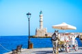 Panorama of the beautiful old harbor of Chania with the amazing lighthouse, mosque, venetian shipyards, at sunset, Crete. Royalty Free Stock Photo