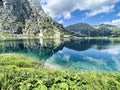 Panorama of beautiful Polish mountains. sunny weather.grassy hill with beautiful flowers and lakes below Royalty Free Stock Photo