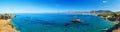 Panorama of beautiful scenery - traditional old fashioned cruise boat docked to the sand shore and colorful blue azure