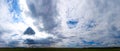 Panorama of Beautiful summer landscape. Countryside with road on the field, green grass, trees and dramatic blue sky with fluffy Royalty Free Stock Photo