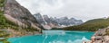 Panorama turquoise water surround with taiga forest and rocky mountain in summer morning at Moraine Lake, Alberta Canada Royalty Free Stock Photo