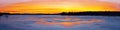 Panorama of the beautifull sunset over the icy river