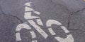 Panorama Bicycle lane sign painted on a road with cracks