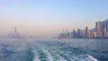 Panorama of the big Asian megalopolis at sunset in a haze, a view of the big city about ship boards, skyscrapers against the backg