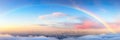 Panorama of a big summer field shined with the sun, with clouds and rainbow in the sky on background Royalty Free Stock Photo