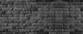 Panorama of black brick wall of dark stone texture and background Royalty Free Stock Photo