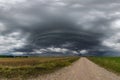 panorama of black sky background with storm clouds. thunder front over gravel road Royalty Free Stock Photo