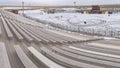 Panorama Bleachers overlooking a sports field covered with snow in winter