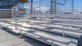 Panorama Bleachers with railings against a building and cloudy blue sky