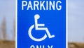 Panorama Blue Reserved Parking Van Accessible sign with a man on a wheelchair icon Royalty Free Stock Photo