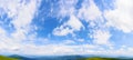 Panorama of a blue sky with fluffy cumulus clouds Royalty Free Stock Photo