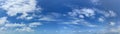 Panorama of a blue sky with white cumulus clouds as a backround Royalty Free Stock Photo