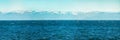 Panorama of blue water of Lake Baikal, with mountain peaks against the sky of summer Royalty Free Stock Photo