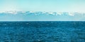 Panorama of blue water of Lake Baikal, with mountain peaks against the sky of summer Royalty Free Stock Photo