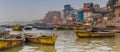 Panorama of boats and historic buildings at the Ganges river in Varanasi