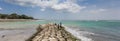 Panorama of boys fishing on the pier of Seminyak on Bali Royalty Free Stock Photo