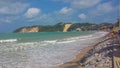 Panorama of brazilian beach with big dunes bathed by ocean waves