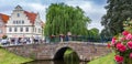 Panorama of a bridge and flowers at the canal in Friedrichstadt Royalty Free Stock Photo