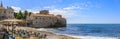 Panorama of Budva Old Town Citadel and Adriatic Sea with an outdoor cafe on Richard s Head beach in Montenegro, Balkans Royalty Free Stock Photo