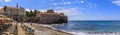 Panorama of Budva Old Town Citadel and Adriatic Sea with an outdoor cafe on Richard s Head beach in Montenegro, Balkans Royalty Free Stock Photo