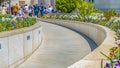 Panorama Building exterior with lush trees and colorful flowers on a sunny spring day Royalty Free Stock Photo