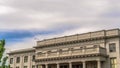 Panorama Building with white wall balcony and security camera on roof against cloudy sky Royalty Free Stock Photo
