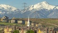 Panorama Buildings church and homes around golf course against snowy mountain and sky Royalty Free Stock Photo