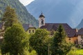 Panorama with buildings, and Parish Church inside Mountain Landscape of Village Log pod Mangartom. Bovec, Slovenia, Europe