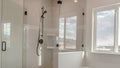 Panorama Built in bathtub with black faucet and shower stall with half glass enclosure Royalty Free Stock Photo