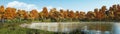 Panorama of calm forest lake shore at autumn day Royalty Free Stock Photo